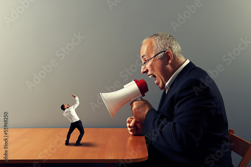 boss screaming at small businessman