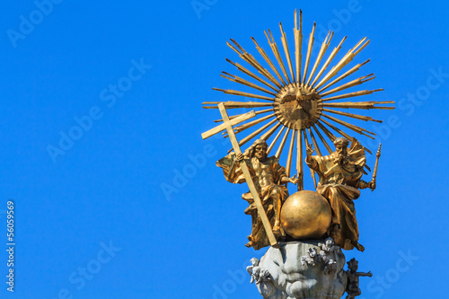 Golden trinity top of a pest column