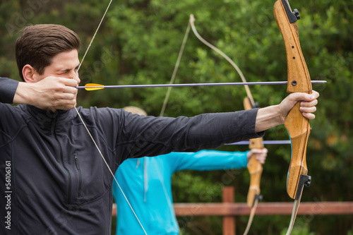 Handsome man practicing archery