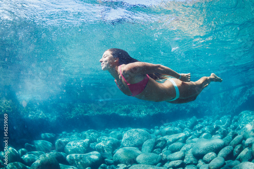 Woman floating in Natural Pool