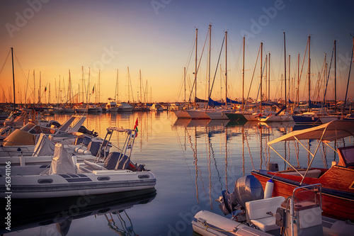 Marina with docked yachts at sunset