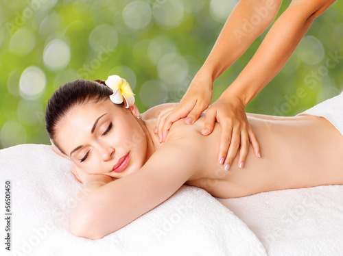 Woman having massage of body in spa salon