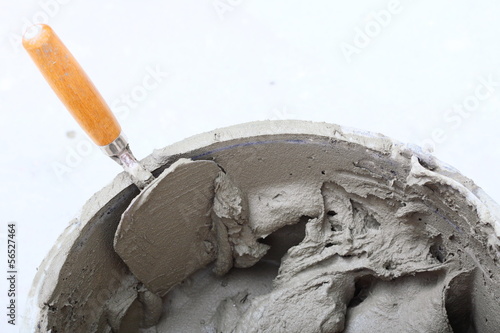 dirty trowel and bucket on building site