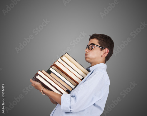 woman carrying stack of books isolated on gray