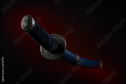 Samurai sword on a black background with red illumination