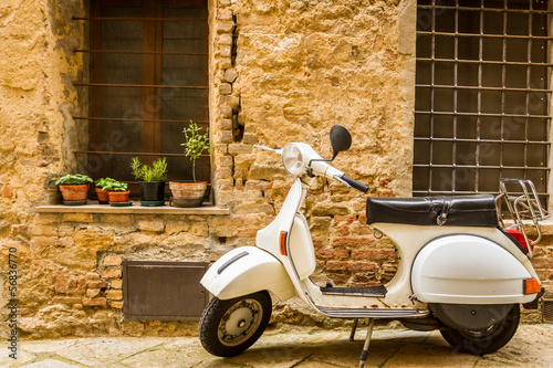 Vintage scene with Vespa on old street