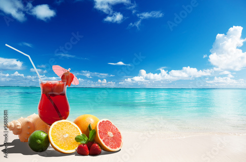 strawberry cocktail and tropical fruit on the beach