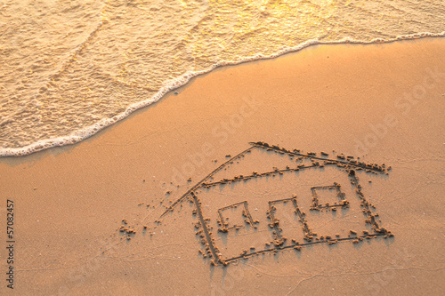 House painted on beach sand.