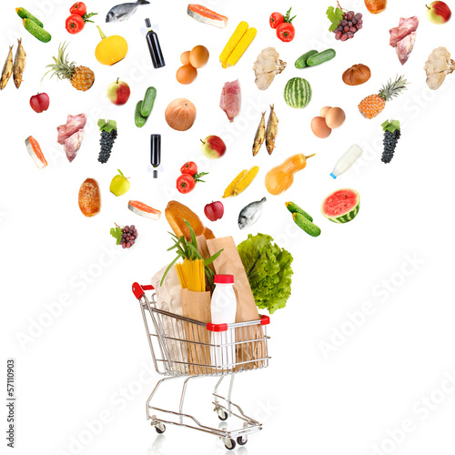 Food products flying out of shopping cart isolated on white
