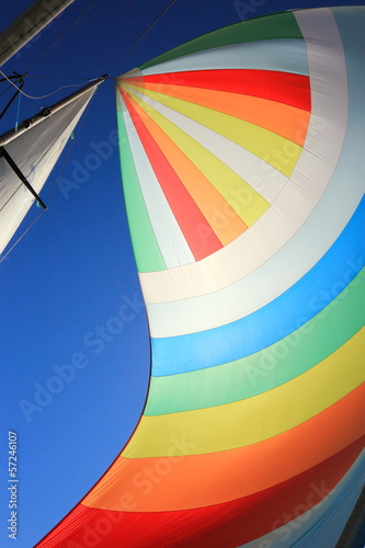 The wind has filled colorful spinnaker sail