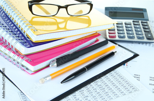 Office supplies with glasses and documents close up