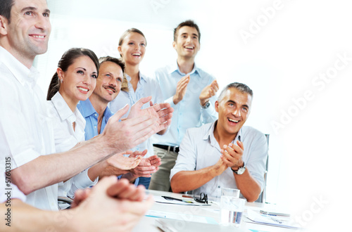 Business people clapping in a meeting