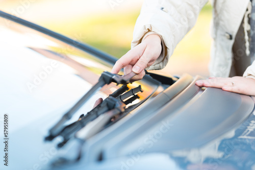 Hand picking up windscreen wiper