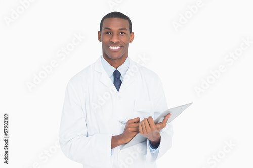 Portrait of a smiling male doctor with clipboard