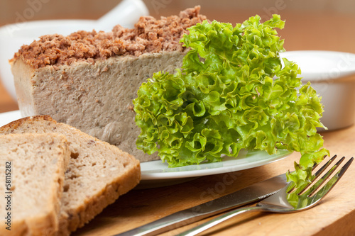 Venison pate on a plate decorated with salad.