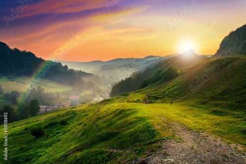 hillside near the village in morning mist