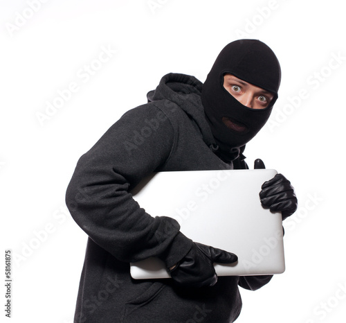 Thief stealing a laptop computer