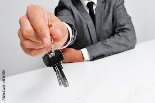 man in suit giving the keys