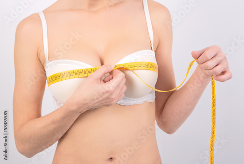 Woman measuring her breasts 