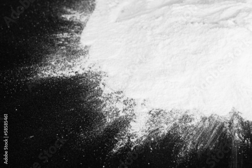 Heap of powdered sugar on black background