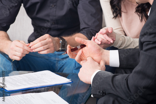 people signing a document