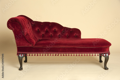 Chaise longue seat covered in a dark red velvet