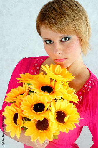 The beautiful blonde with a bouquet of yellow flowers