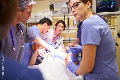 Medical Team Working On Patient In Emergency Room