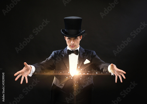 magician in top hat showing trick