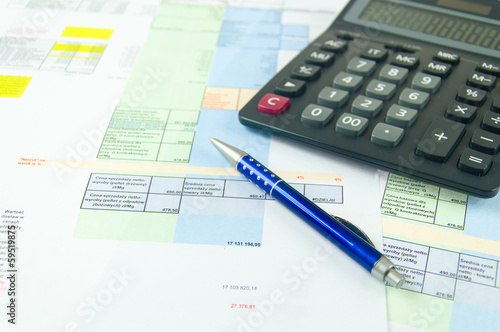 financial statement with calculator and pen