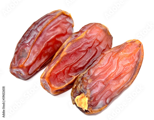 dry date palm fruits on white background