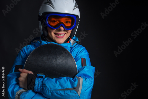 Beautiful smiling happy sportswoman hugging snowboard.