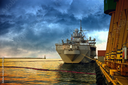 Warship in the port of dramatic scenery.