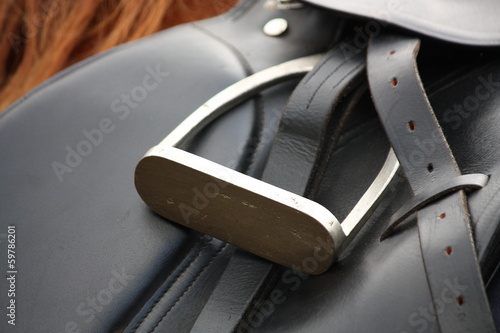 Close up of black saddle on horse back