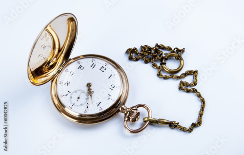 Gold pocket watch on white