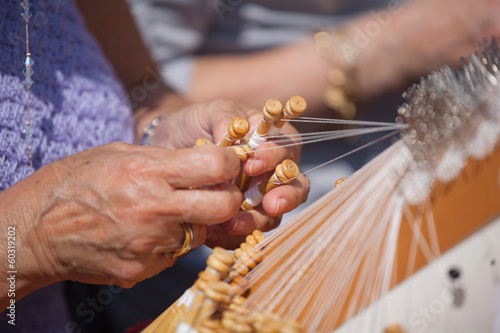 Women`s hands, tatting