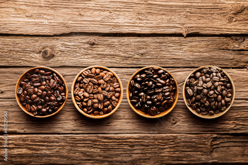 Assorted coffee beans on a driftwood background