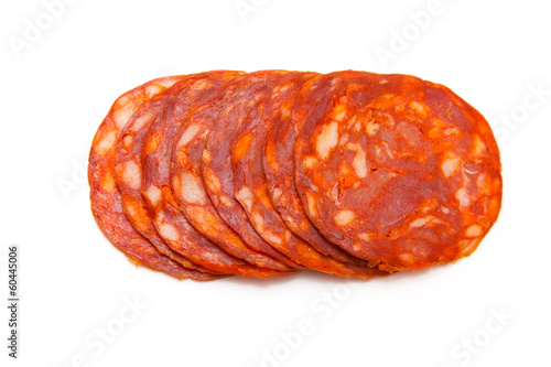 Sliced chorizo sausage isolated on a white studio background.