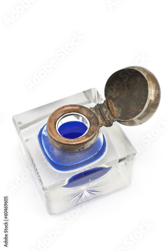 Antique crystal inkwell with blue ink isolated on white