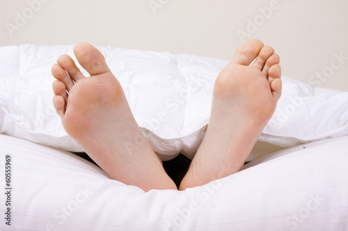 feet in the foreground in the covered bed