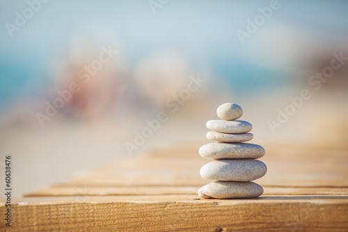 zen stones jy wooden banch on the beach near sea. Outdoor