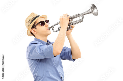 Young male musician playing trumpet