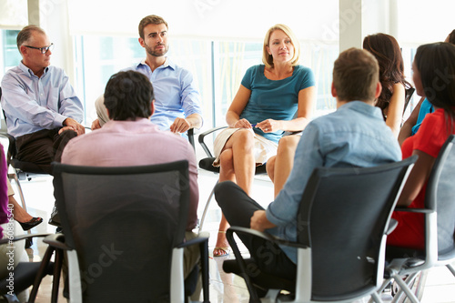 Multi-Cultural Office Staff Sitting Having Meeting Together