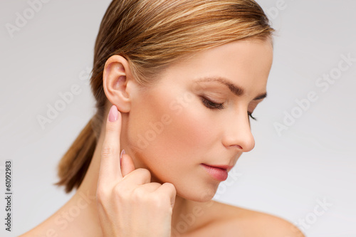 calm woman touching her ear