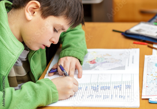 bored and tired boy doing homework