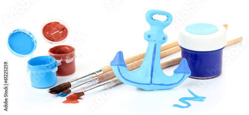 Hand made ceramic anchor and color paints isolated on white