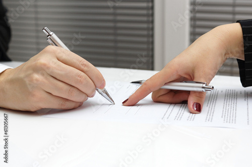 businesswoman point with finger on paper to sign up contract