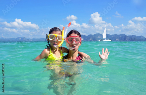 Happy mother and kid snorkeling in tropical sea, family vacation