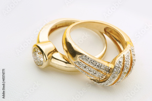 Jewelry Elegant Gold wedding or engagement rings with diamond on white background close up