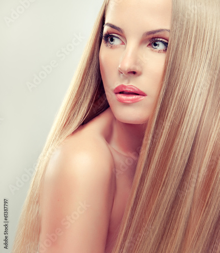 Beautiful blonde woman with long, healthy and shiny hair.